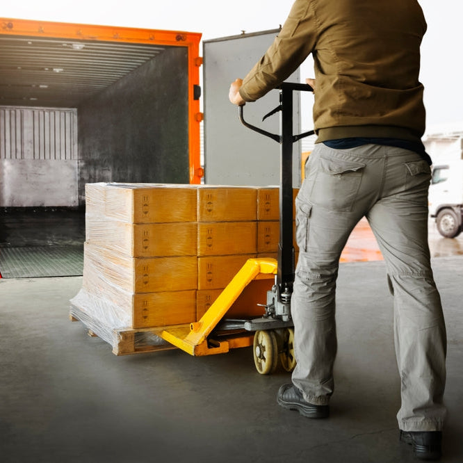 Workers Unloading Packaging Boxes on Pallets into The Cargo Container